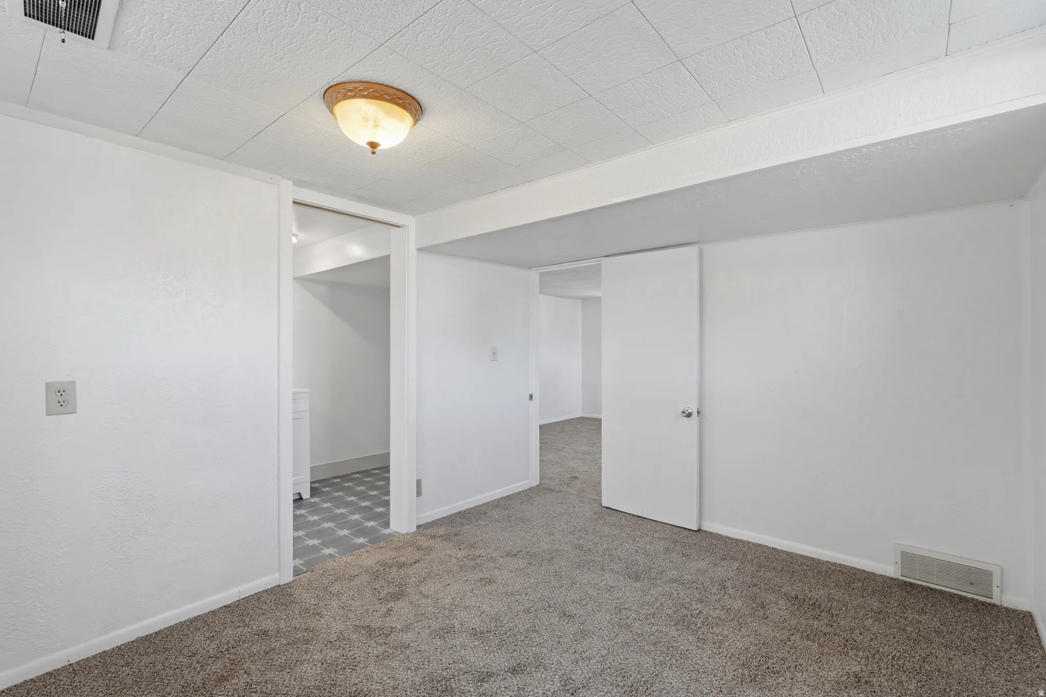 Interior room featuring neutral-toned carpeting and white painted walls