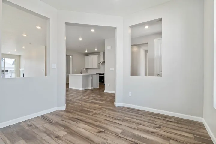 Open concept living space featuring wood-finish flooring throughout