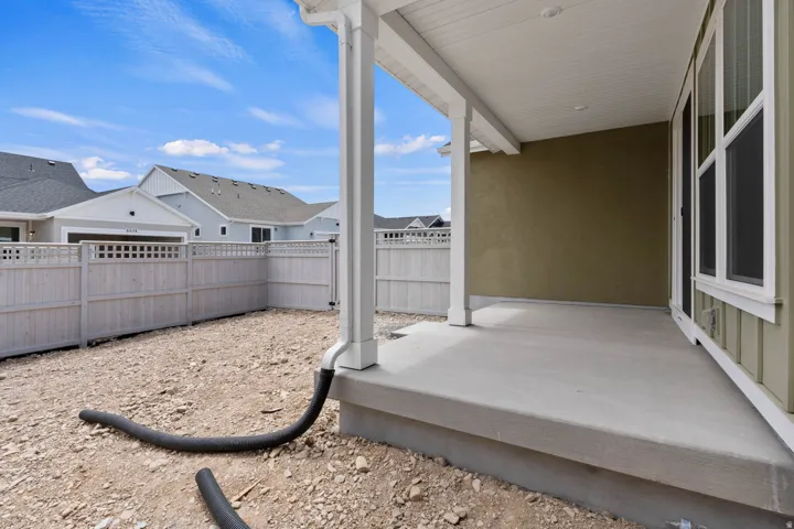 Covered patio featuring a concrete slab and painted wood support columns