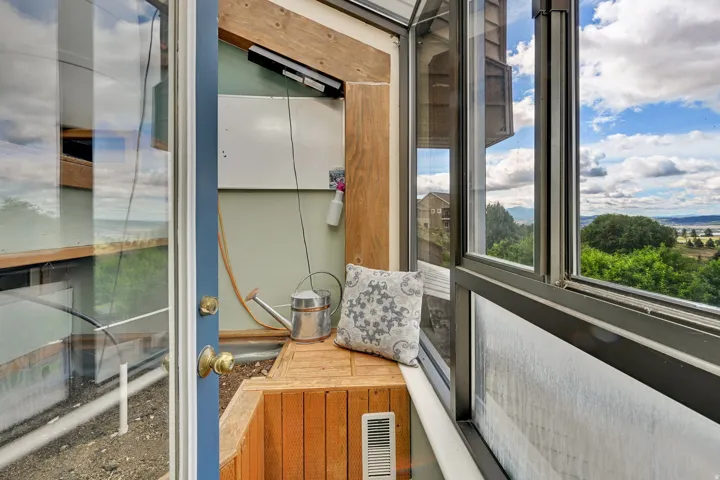 Sunroom with wood-finish flooring and built-in bench seating