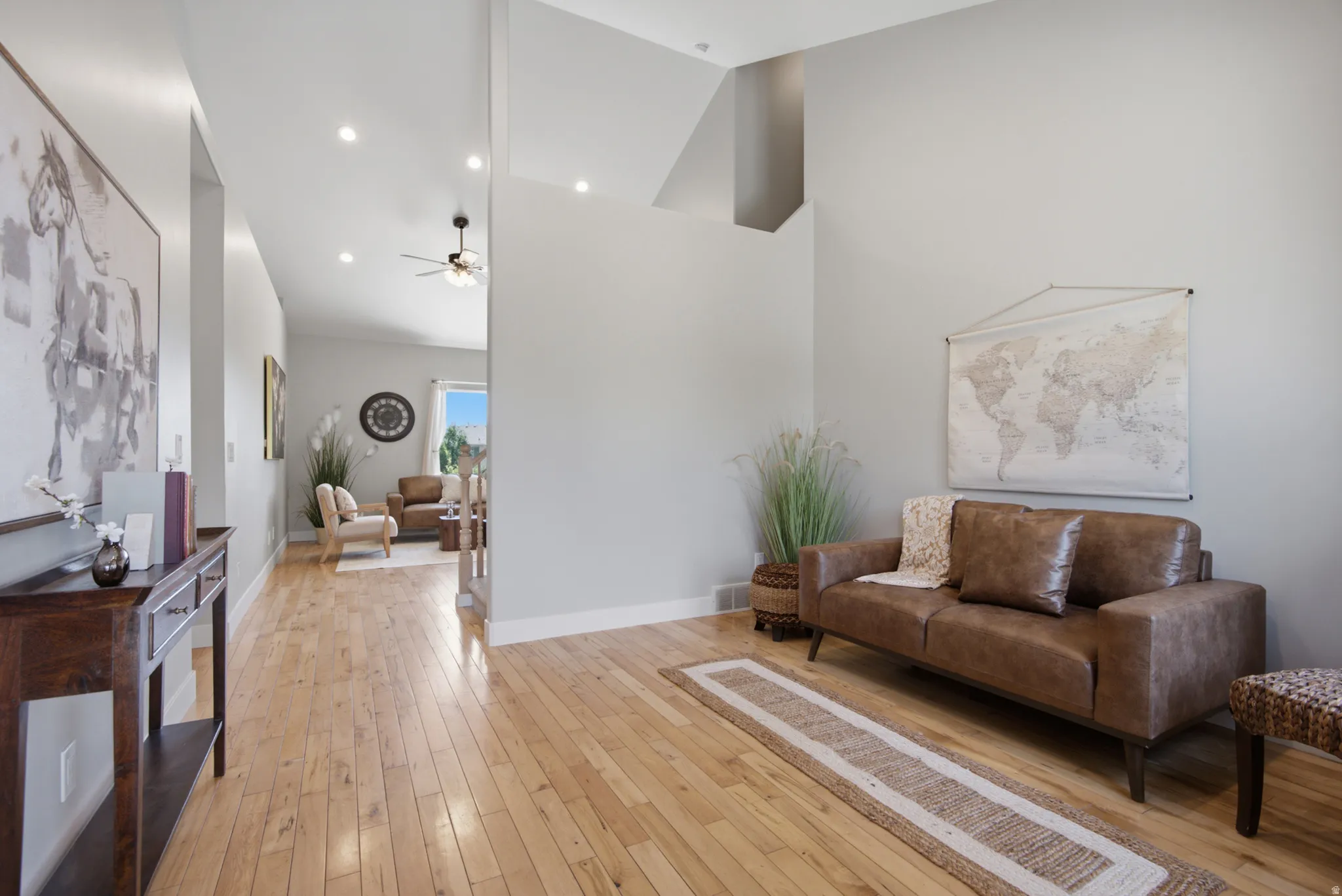 Spacious interior featuring light wood-finish flooring, recessed lighting, and vaulted ceilings