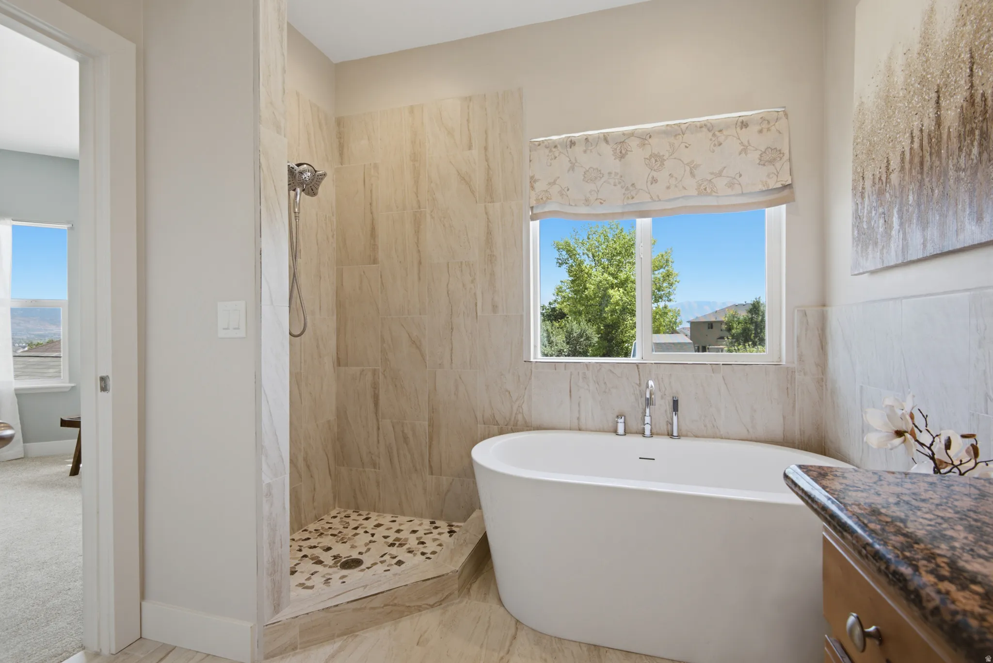 Freestanding soaking tub with floor-mounted faucet