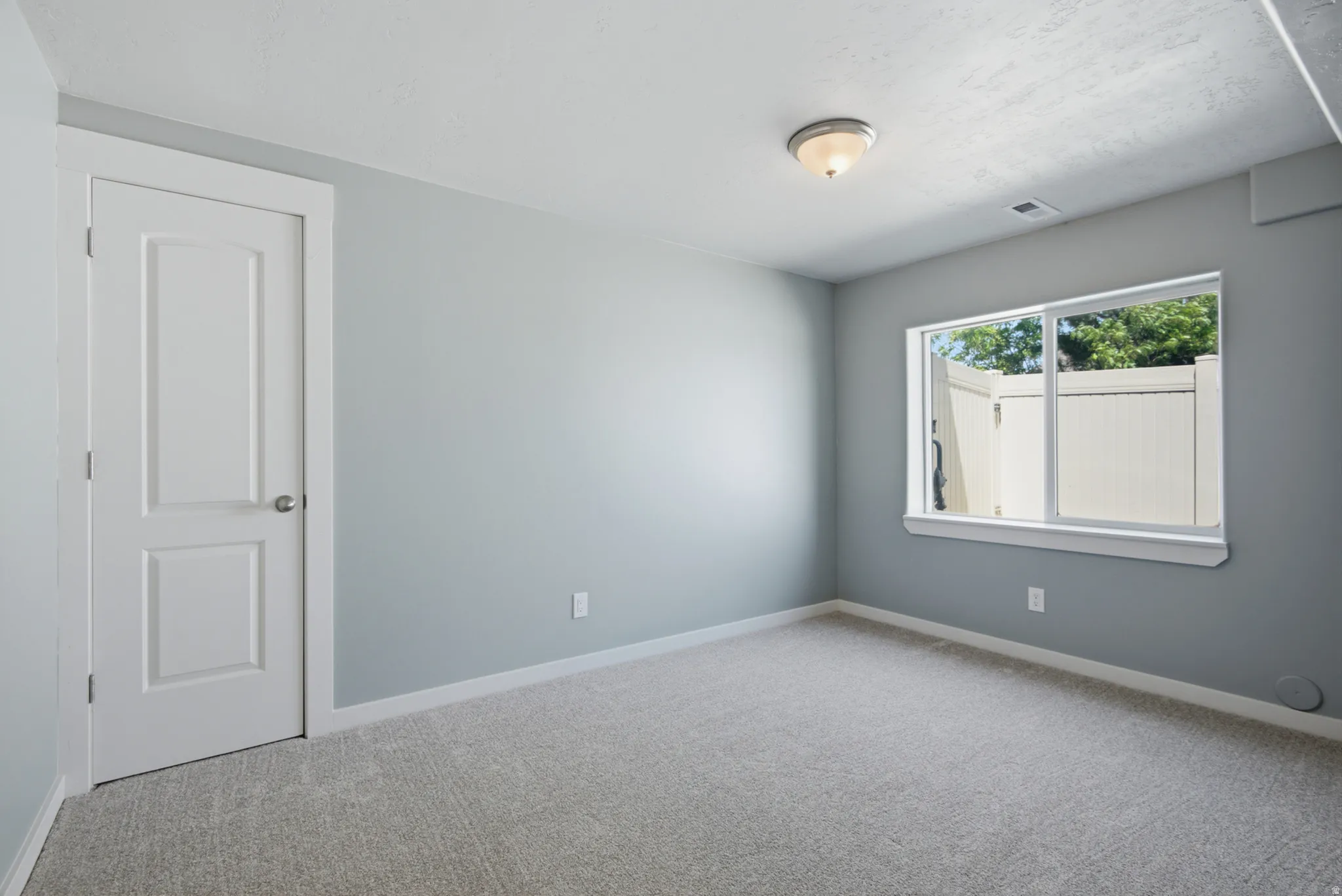 Light gray wall paint complemented by white trim and a paneled door