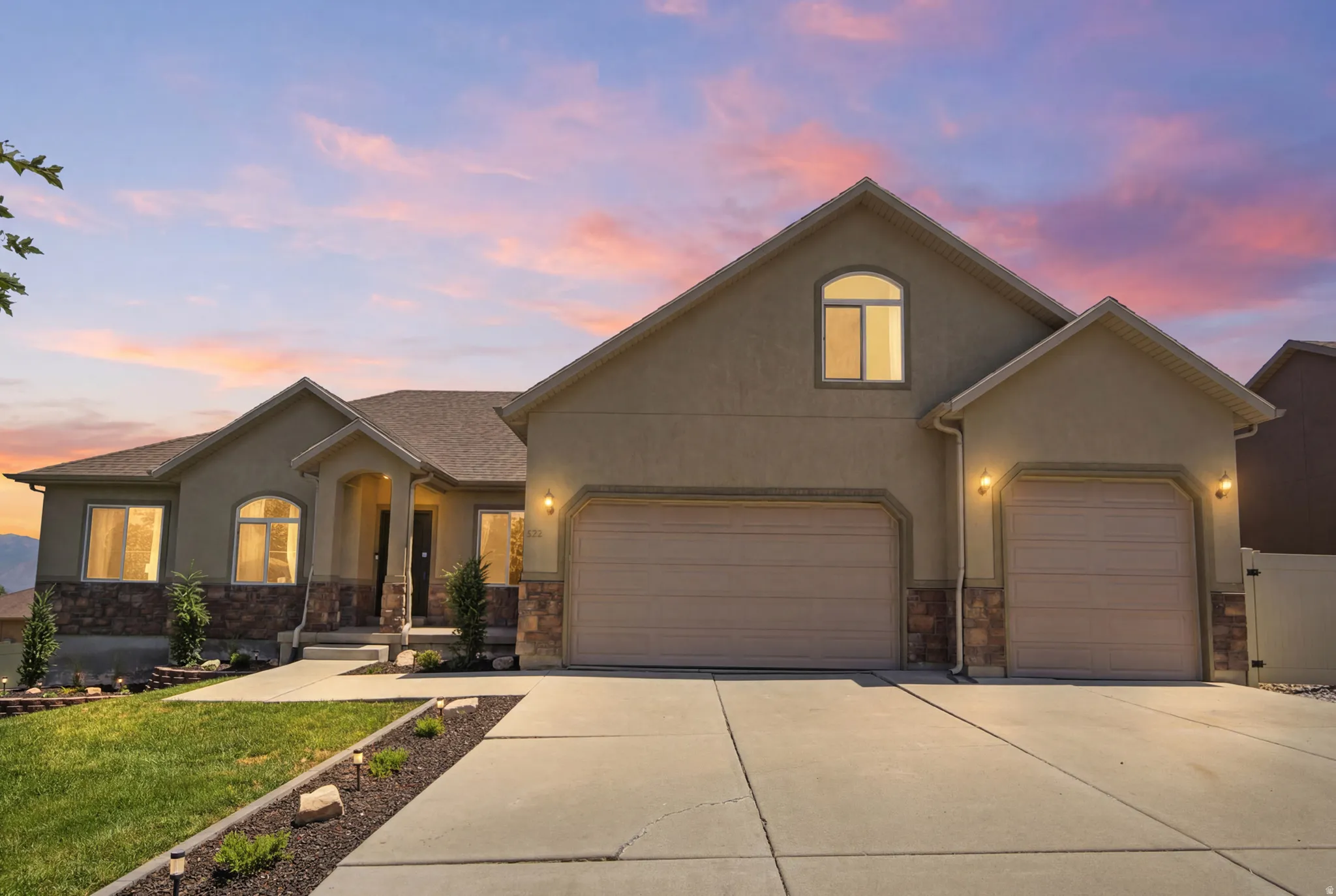 Stucco exterior with stone accents and an arched entry