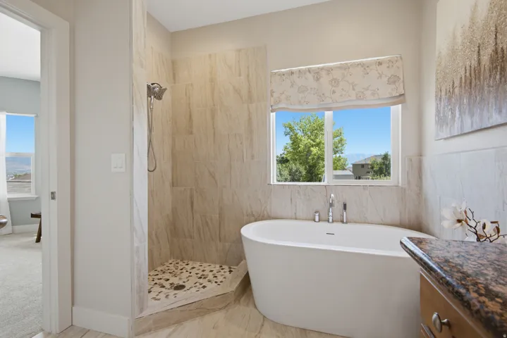 Freestanding soaking tub with floor-mounted faucet