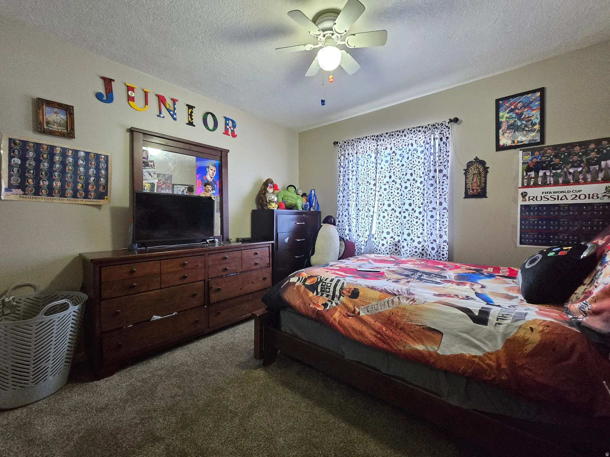 Room featuring a ceiling fan with integrated lighting, window with curtain rod, and wall-to-wall carpeting