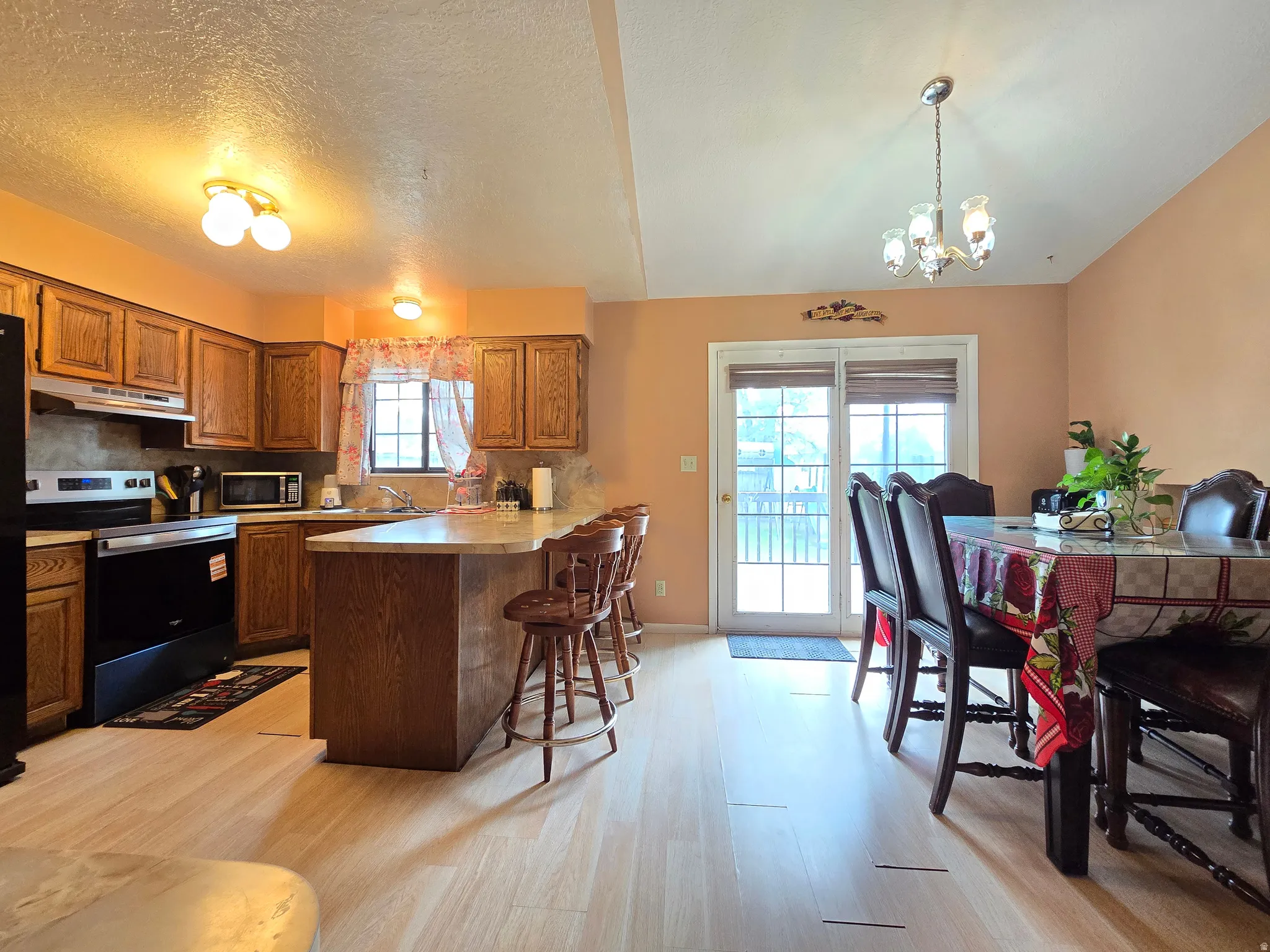 Open concept kitchen and dining area with wood-finish flooring