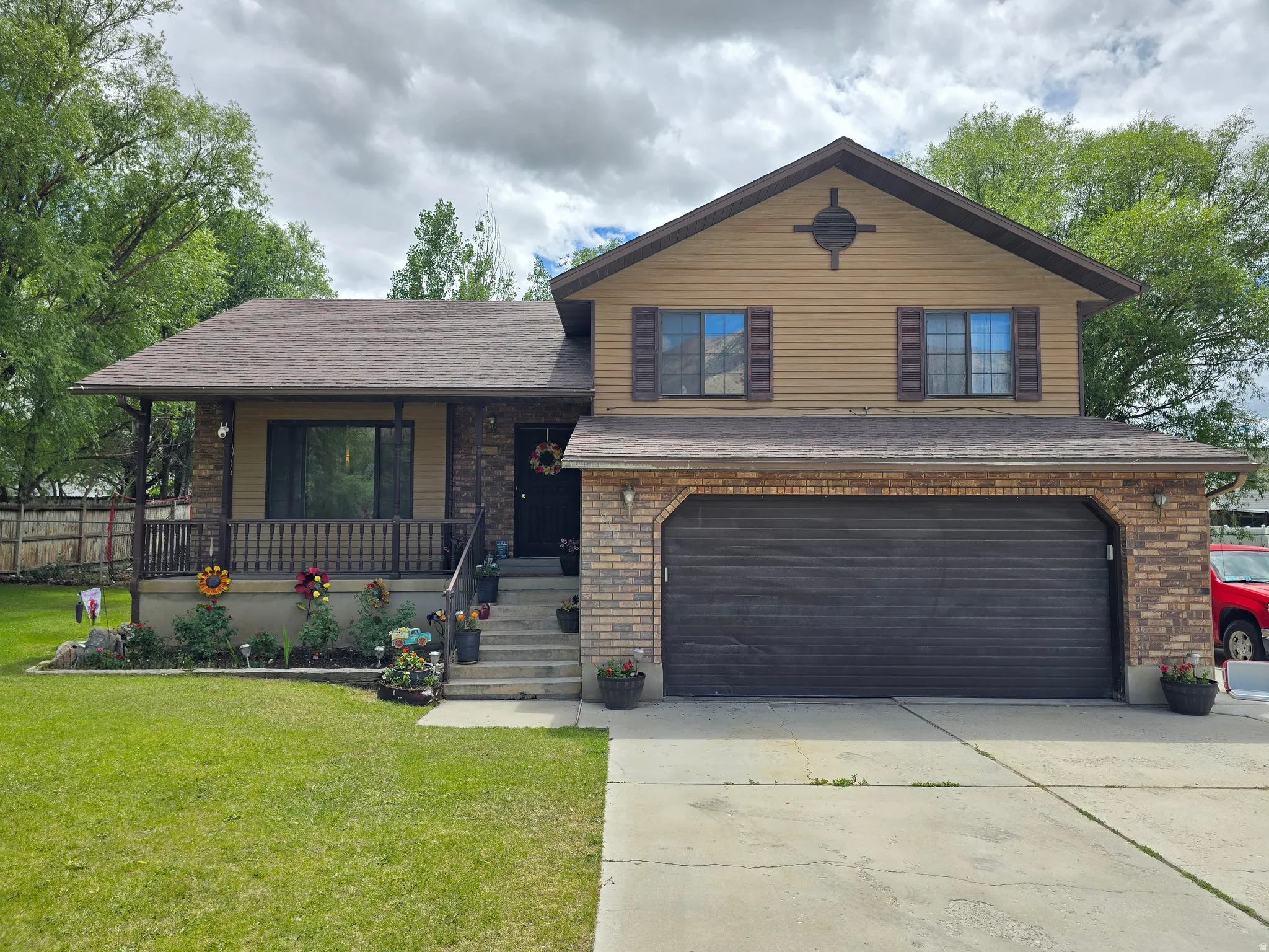 Two-story residence featuring a brick and siding exterior