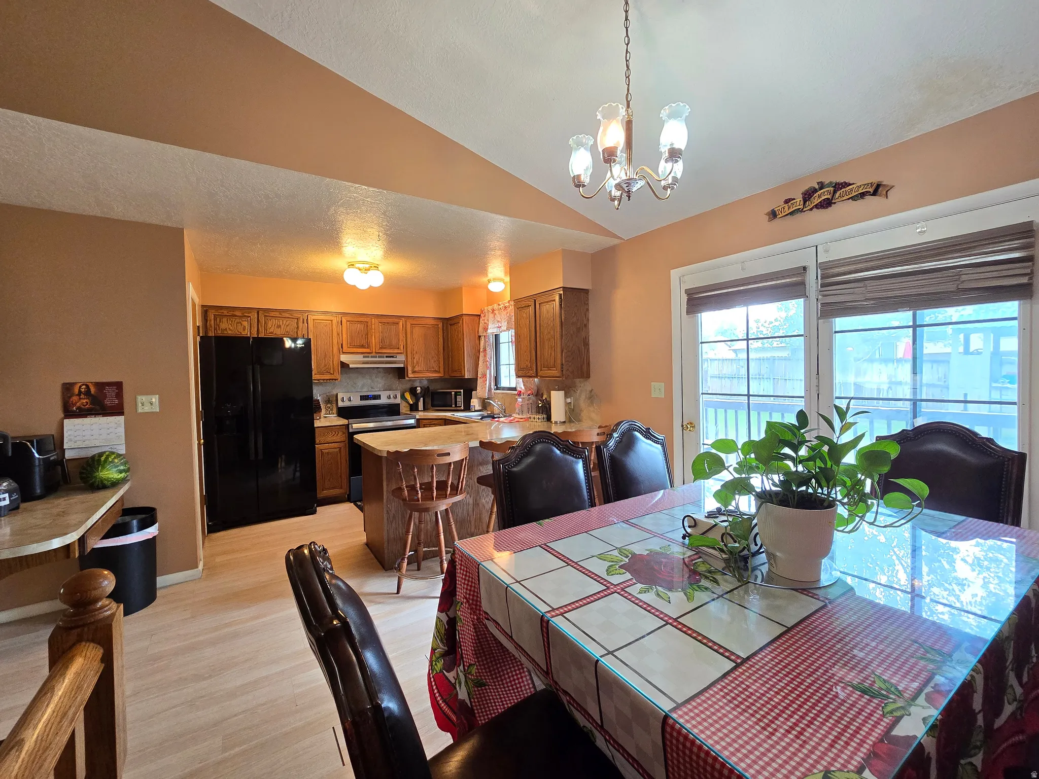 Kitchen and dining area featuring light wood-finish flooring