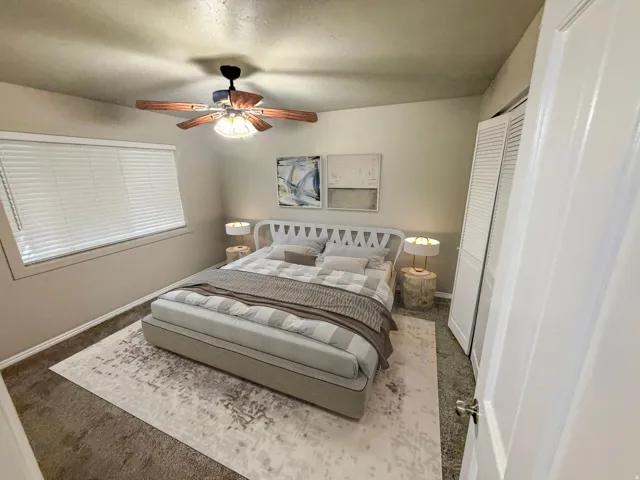 Bedroom featuring a window with blinds, a ceiling fan with integrated lighting, and carpet flooring