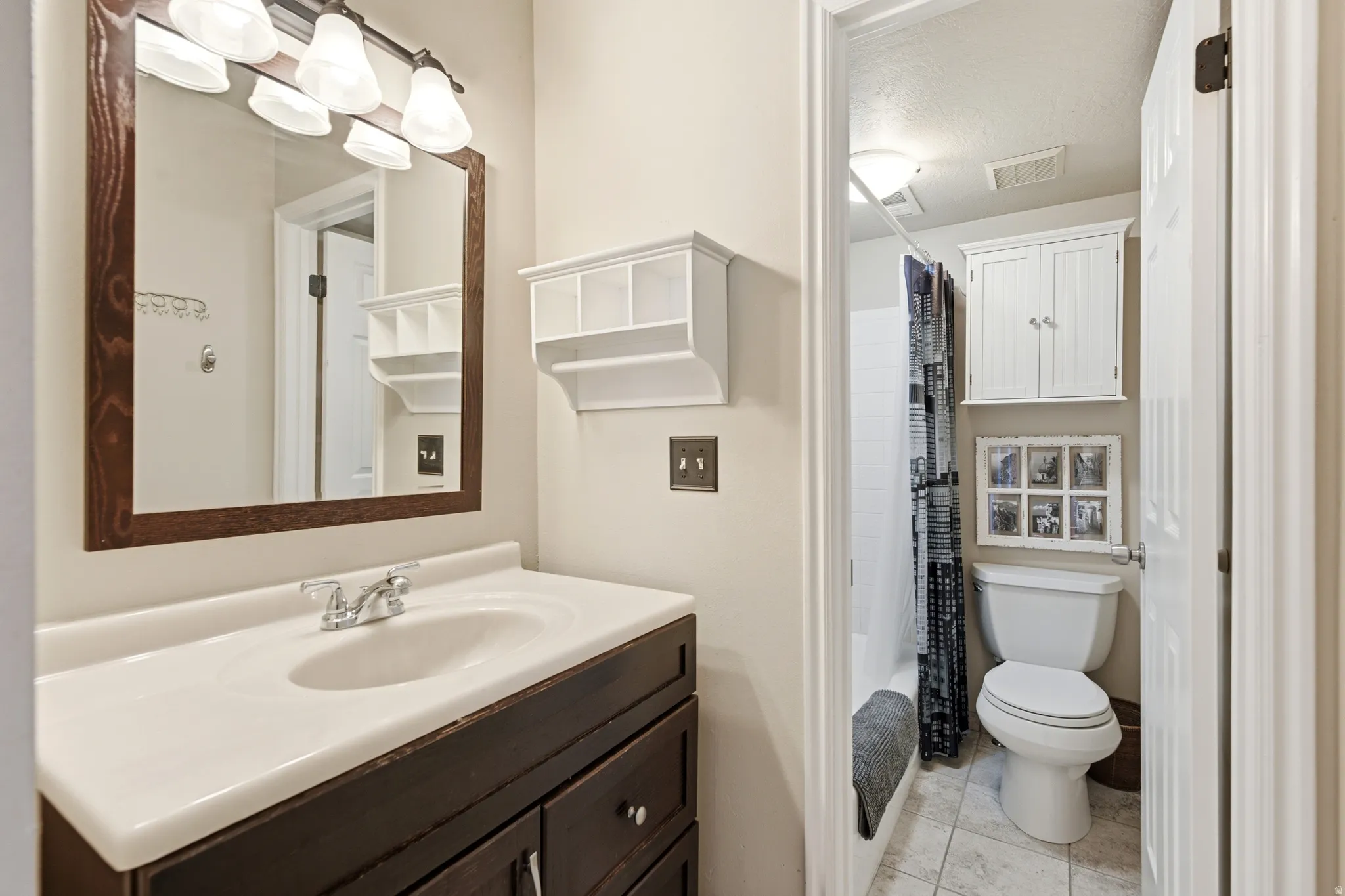 Bathroom with a vanity featuring a white countertop and dark wood-finish cabinetry