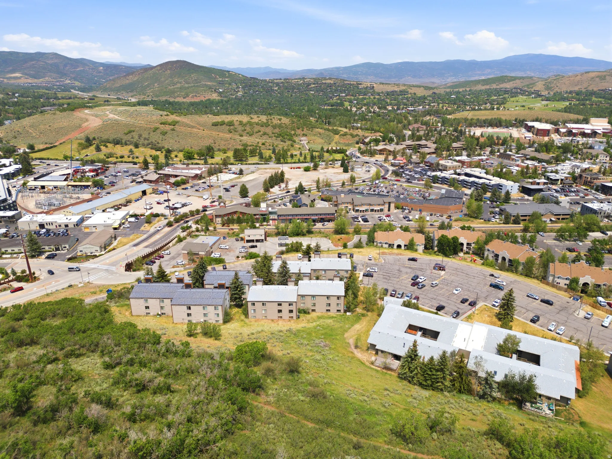 Aerial perspective showcasing multiple residential structures and commercial buildings