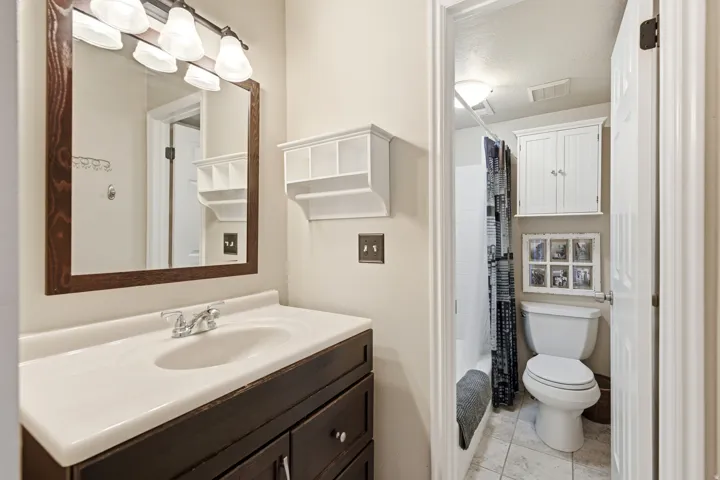 Bathroom with a vanity featuring a white countertop and dark wood-finish cabinetry