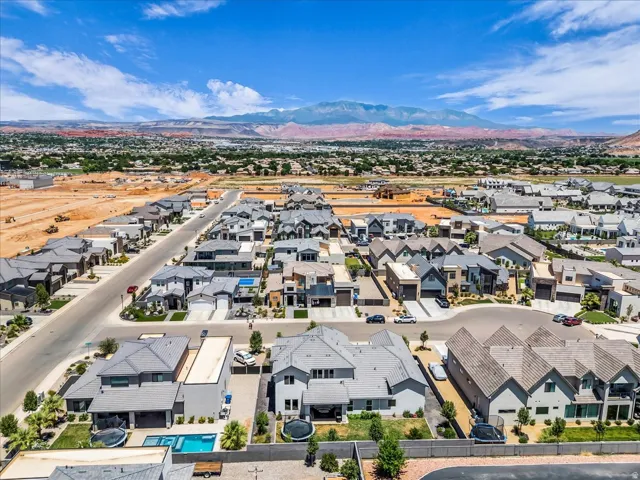 Aerial perspective showcasing a developed residential neighborhood with distant mountain scenery