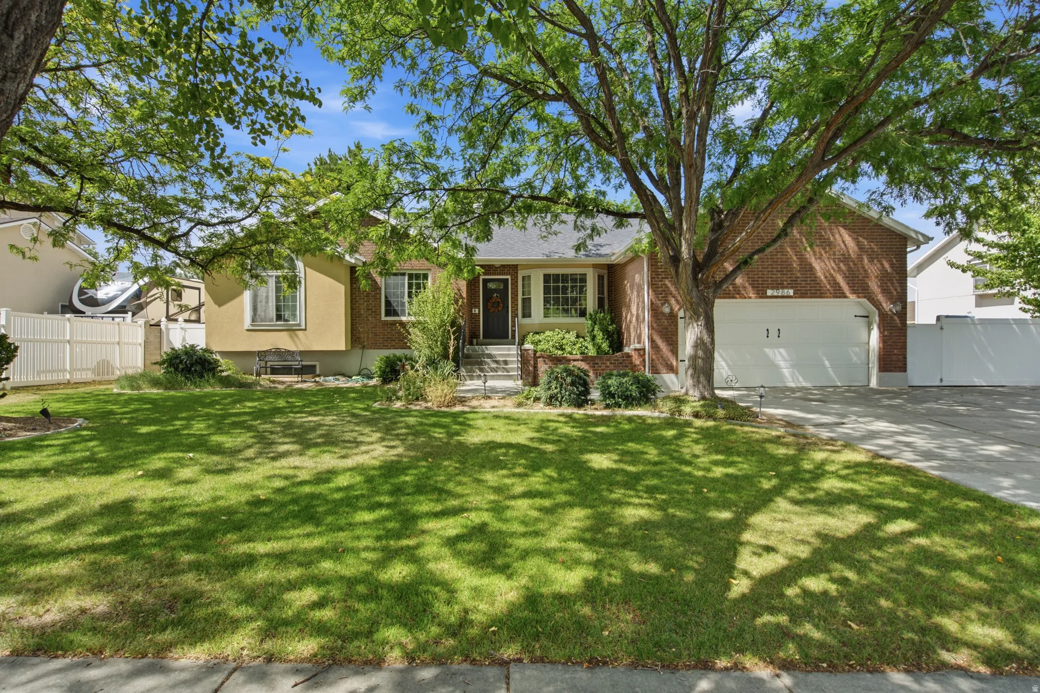 Brick and stucco exterior with a prominent attached garage