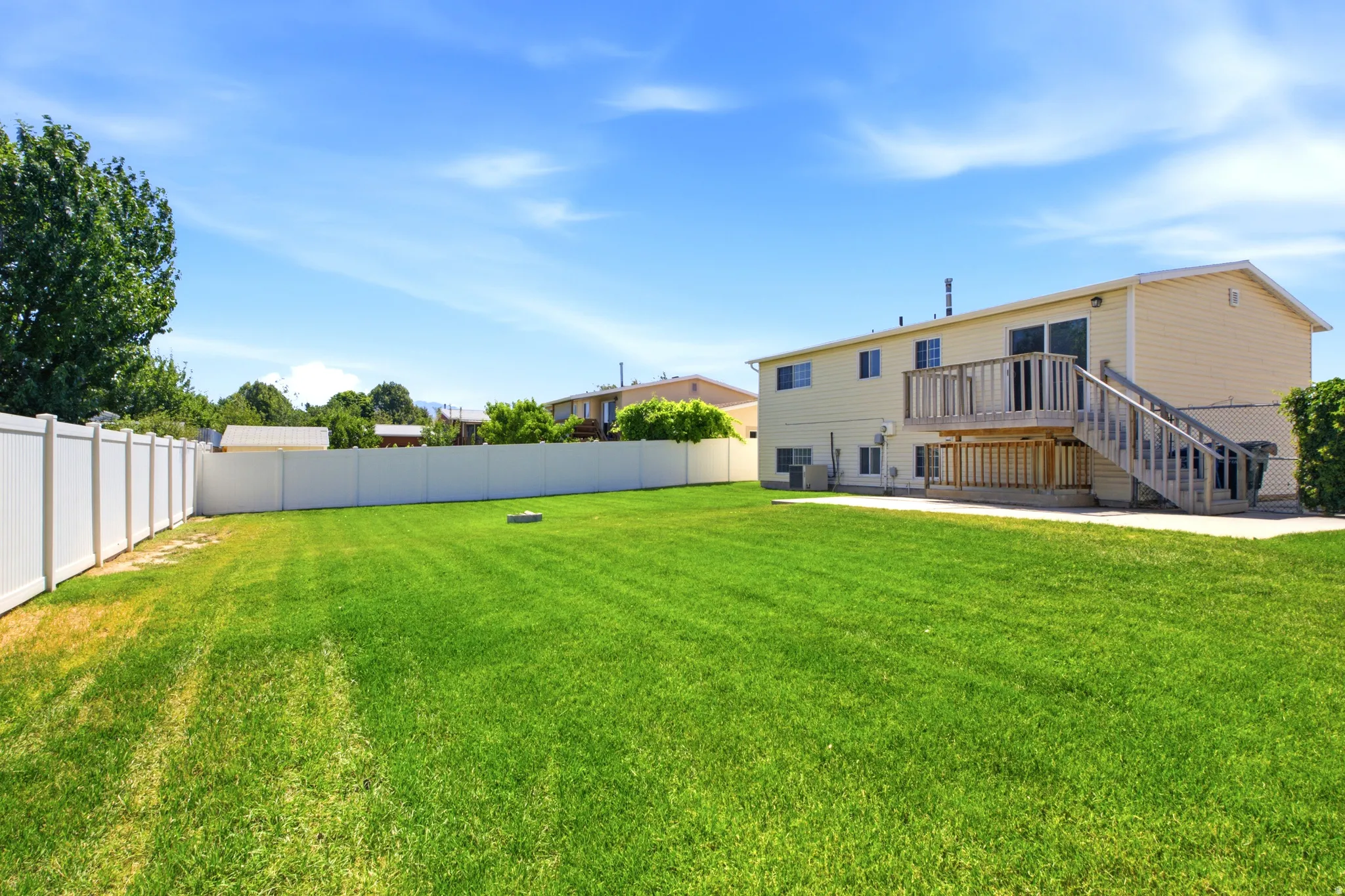 Spacious rear yard featuring an expansive lawn area