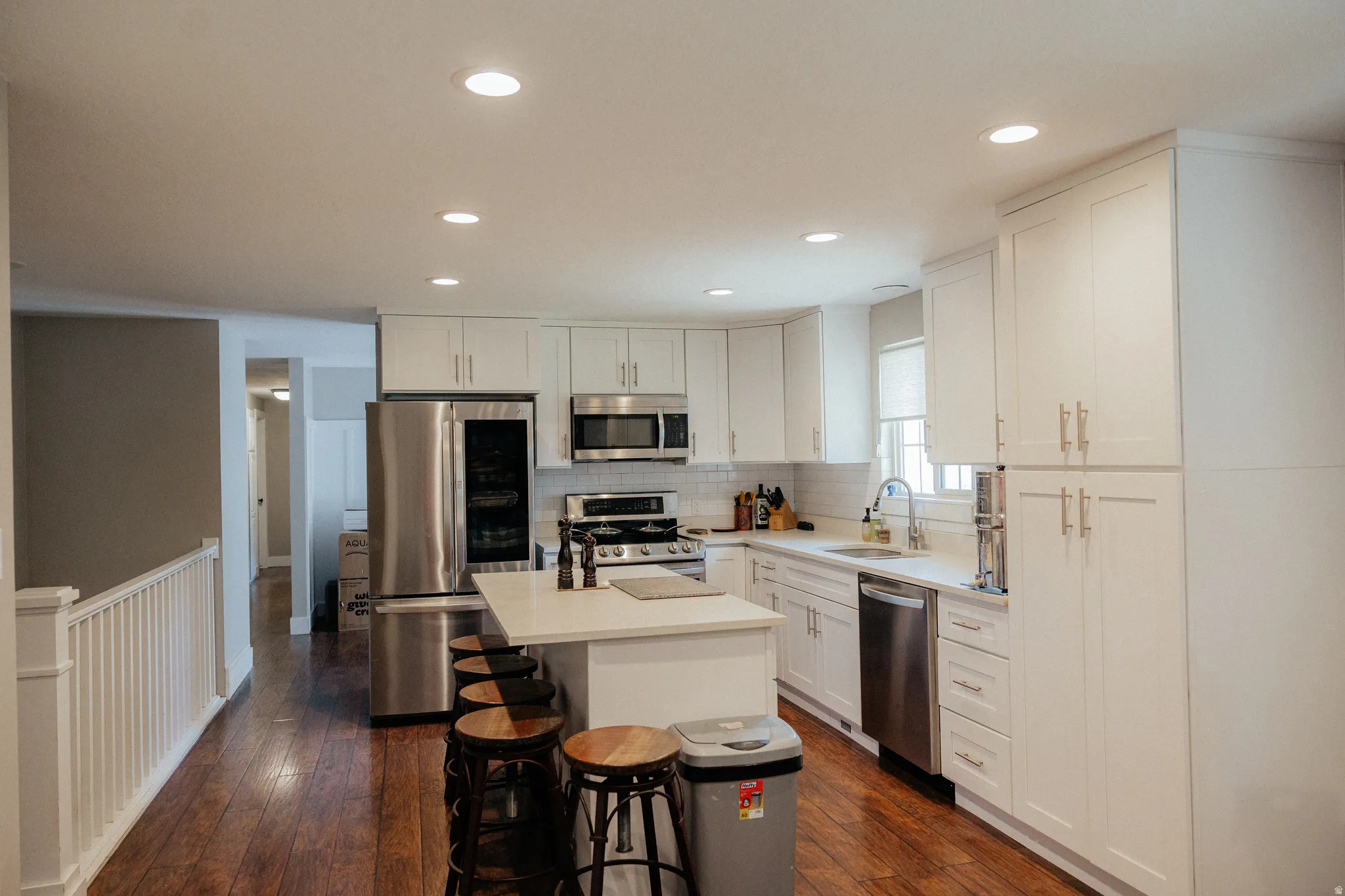 You'll love that this kitchen has not only room for a quick bit to eat at the island but there is also room for a kitchen table as well.