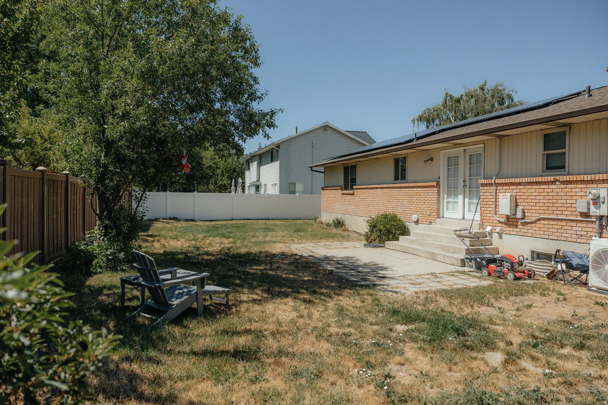 Expansive backyard featuring mature trees, and room to run and play and garden.