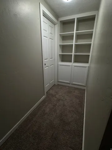Just as you come downstairs to the basement you are greeted with this all to the left that leads to the 4th bedroom.  The built in cupboards and shelves make the space functional and pretty.