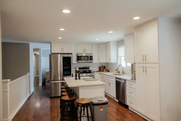 You'll love that this kitchen has not only room for a quick bit to eat at the island but there is also room for a kitchen table as well.