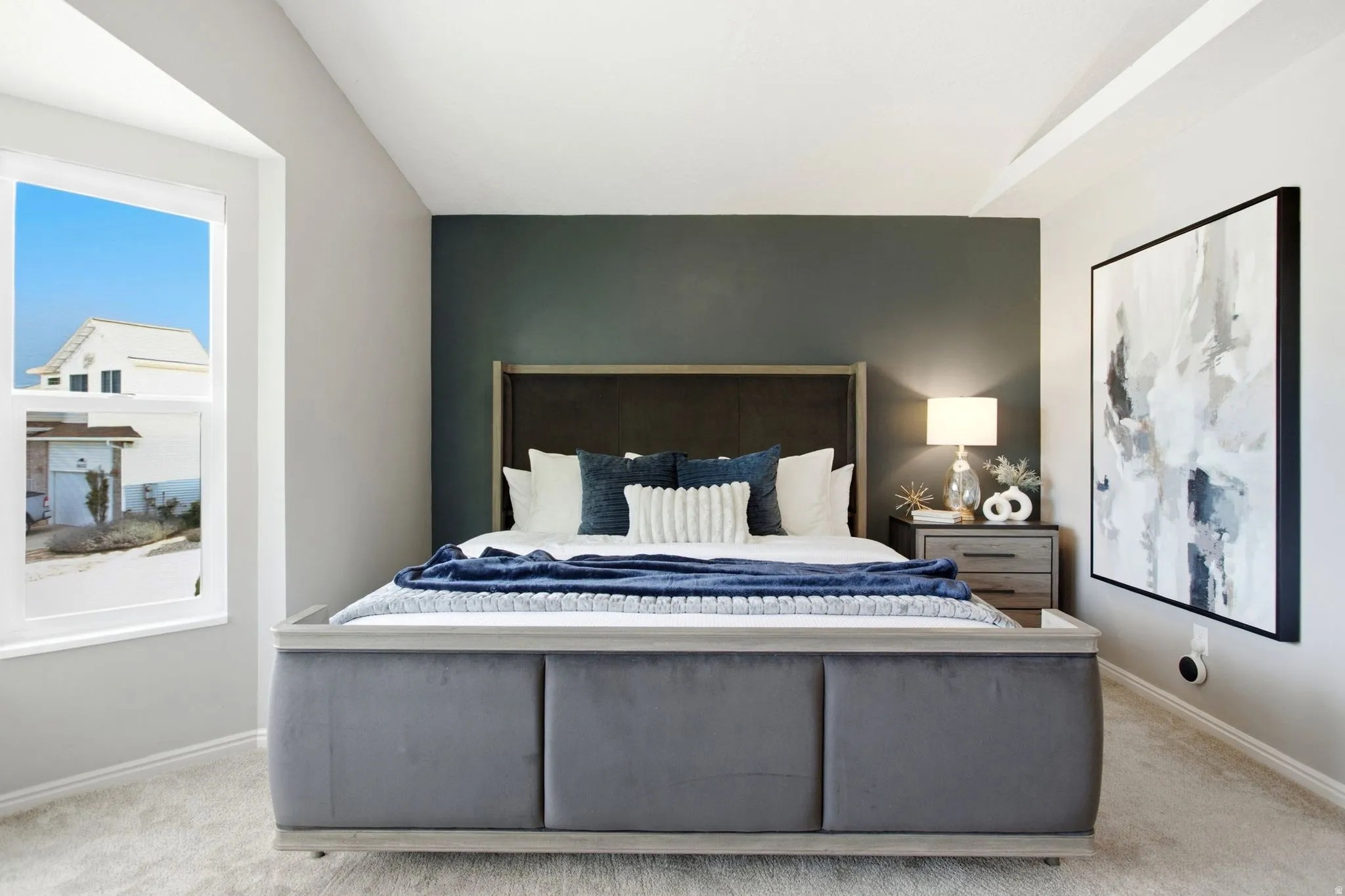 Recessed lighting, tray ceiling, accent wall, carpeted flooring, and a large window