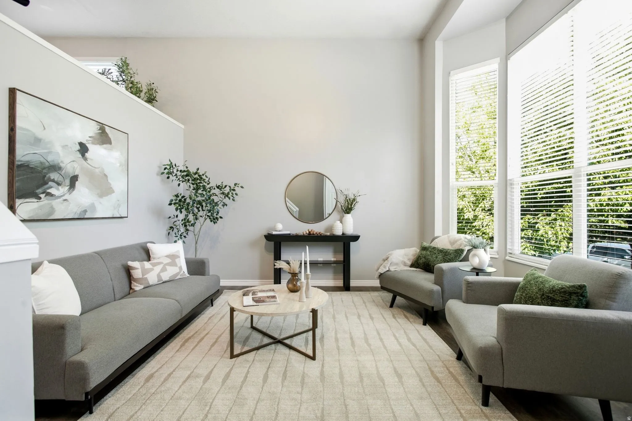 High ceilings, wood-finish flooring, and large windows with blinds