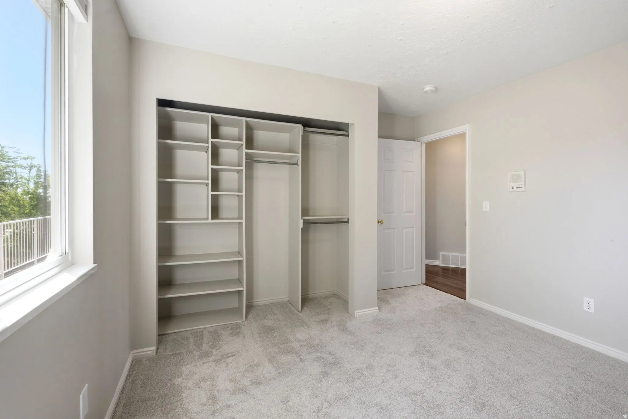 Built-in closet organization system featuring shelving and hanging rods