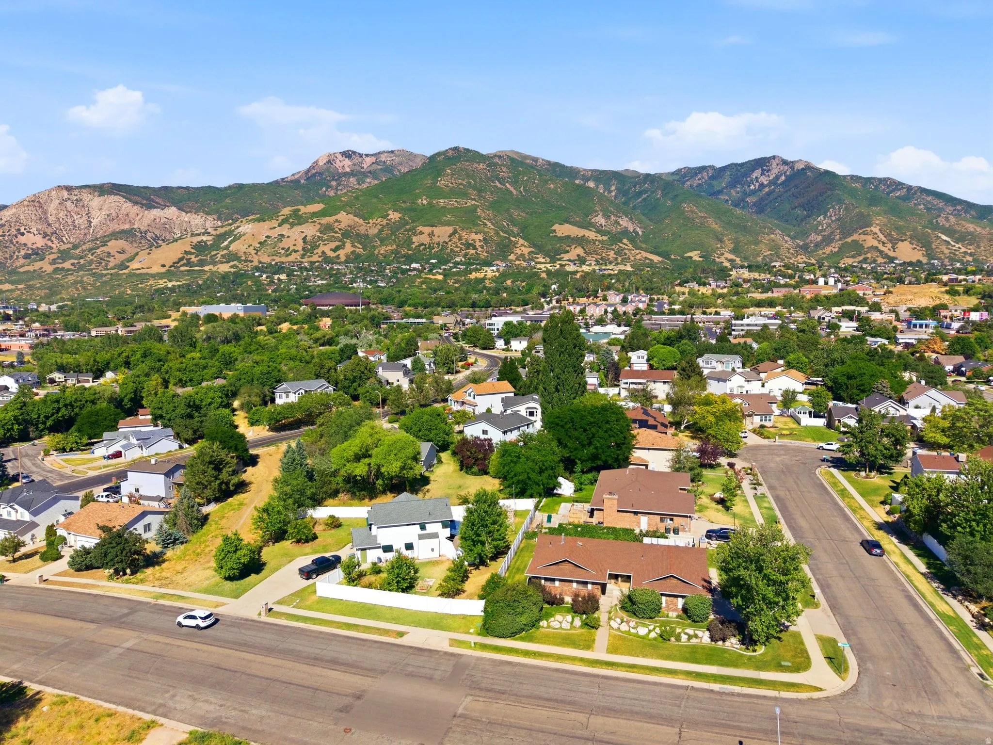 Aerial perspective of a residential neighborhood with prominent mountain backdrop