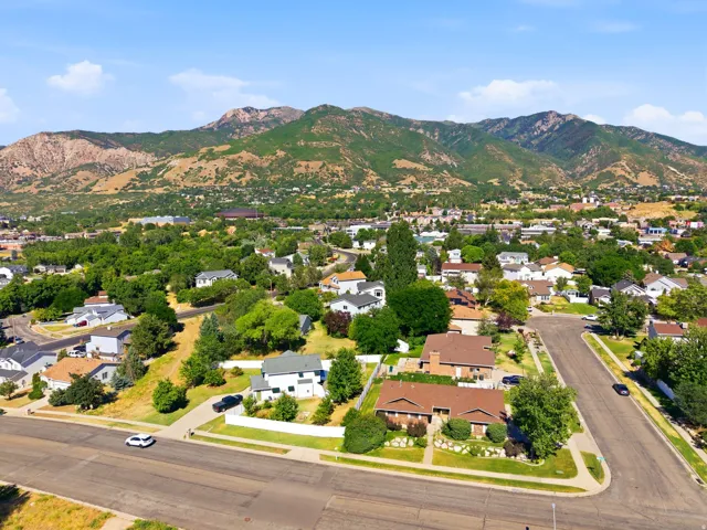 Aerial perspective of a residential neighborhood with prominent mountain backdrop