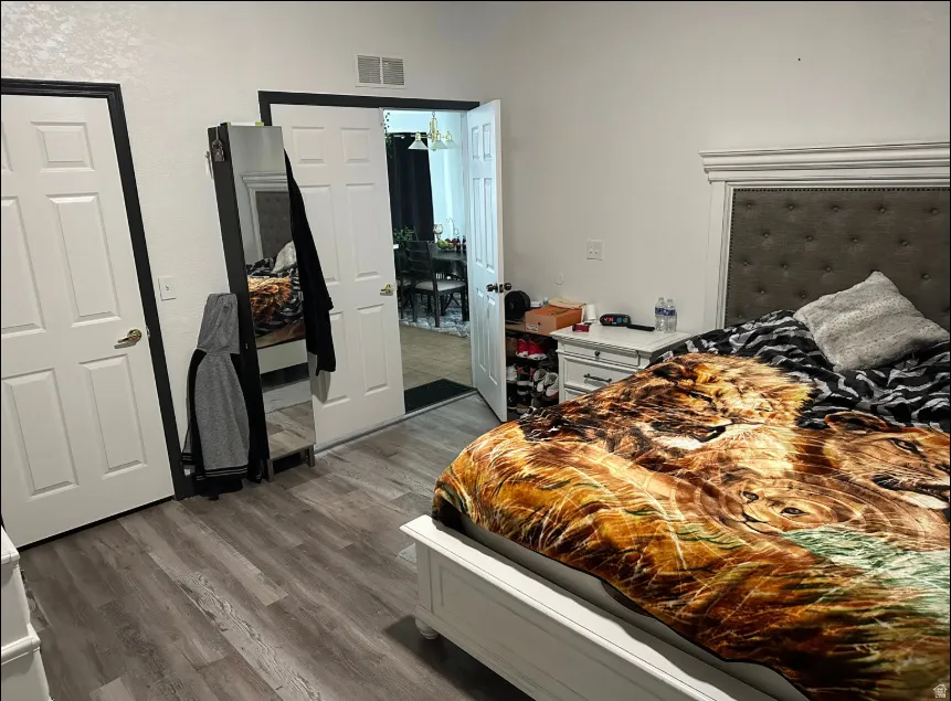 Bedroom featuring wood-finish flooring and white paneled doors