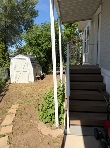 Exterior staircase featuring wood-finish treads and white risers