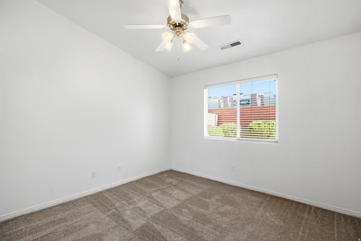 Room featuring light-colored walls and carpeted flooring