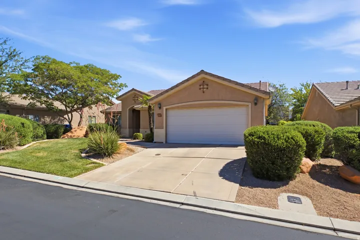 Stucco exterior with a tiled roof and an attached garage
