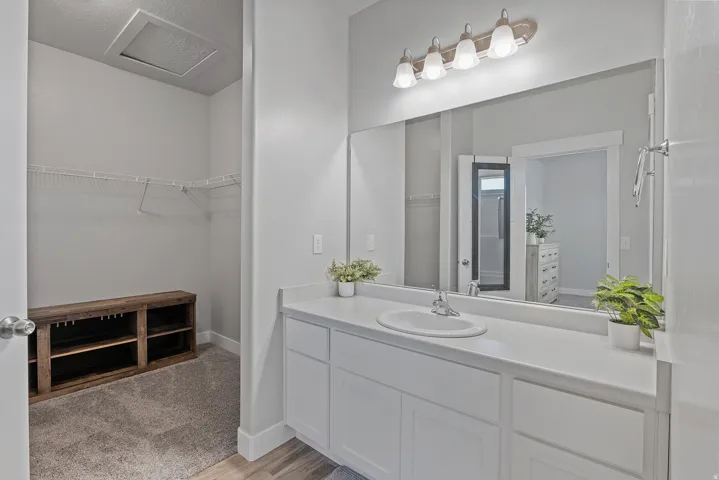 Bathroom vanity with a spacious countertop, integrated sink, and white cabinetry
