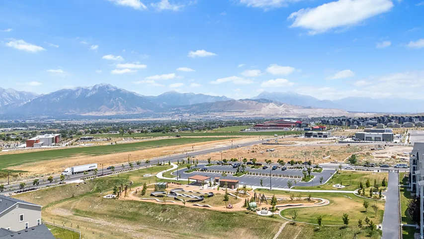 Expansive mountain range backdrop framing a developing community with infrastructure