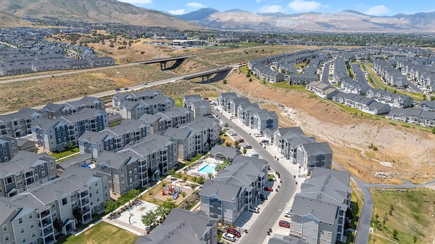 Aerial perspective showcasing a residential community with multi-story apartment buildings and single-family homes