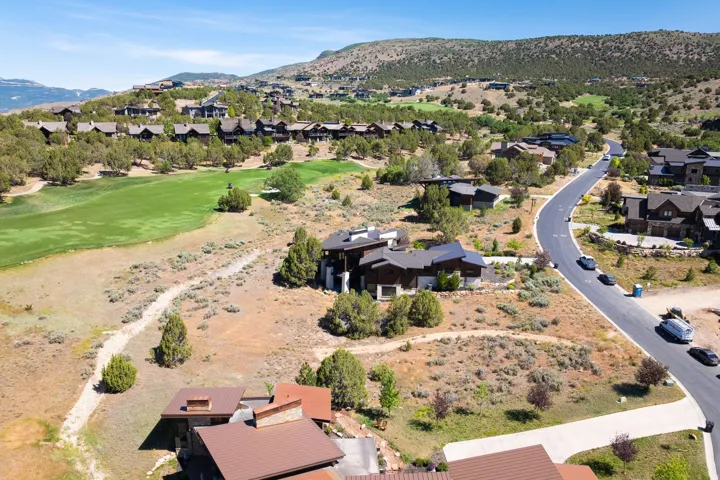 Sweeping aerial perspective of a residential community nestled among rolling hills