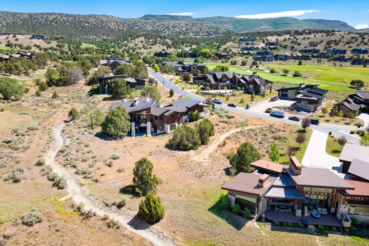 Expansive mountain scenery with diverse residential architecture and a golf course