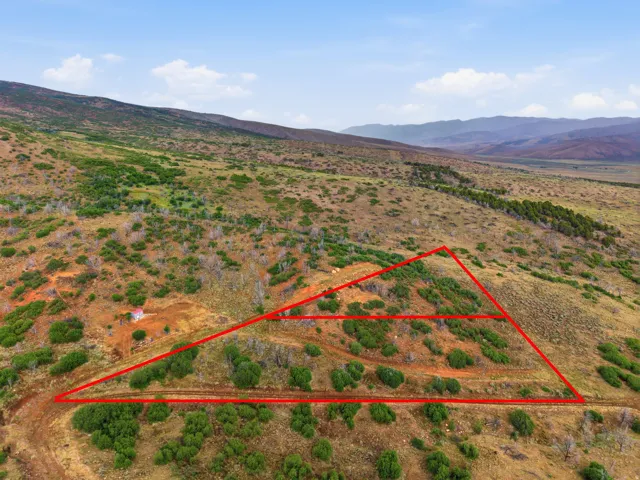 Expansive undeveloped land featuring varied terrain and distant mountain ranges