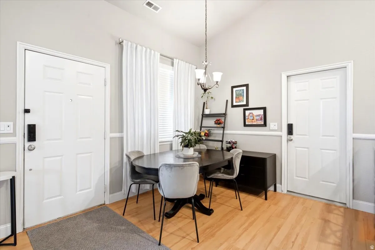 Dining area featuring wood-finish flooring and vaulted ceilings