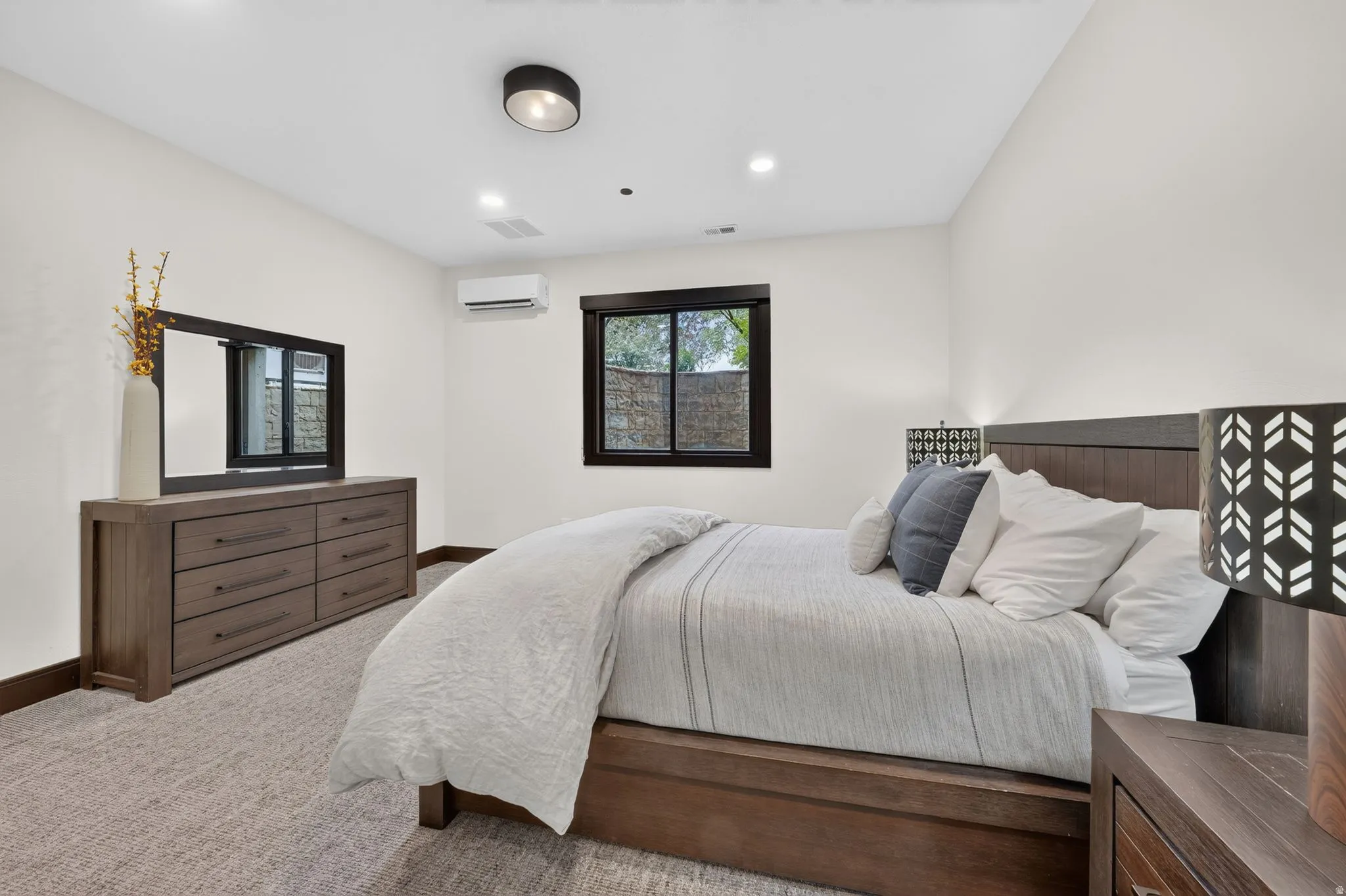 Bright white walls complement the neutral carpeted flooring