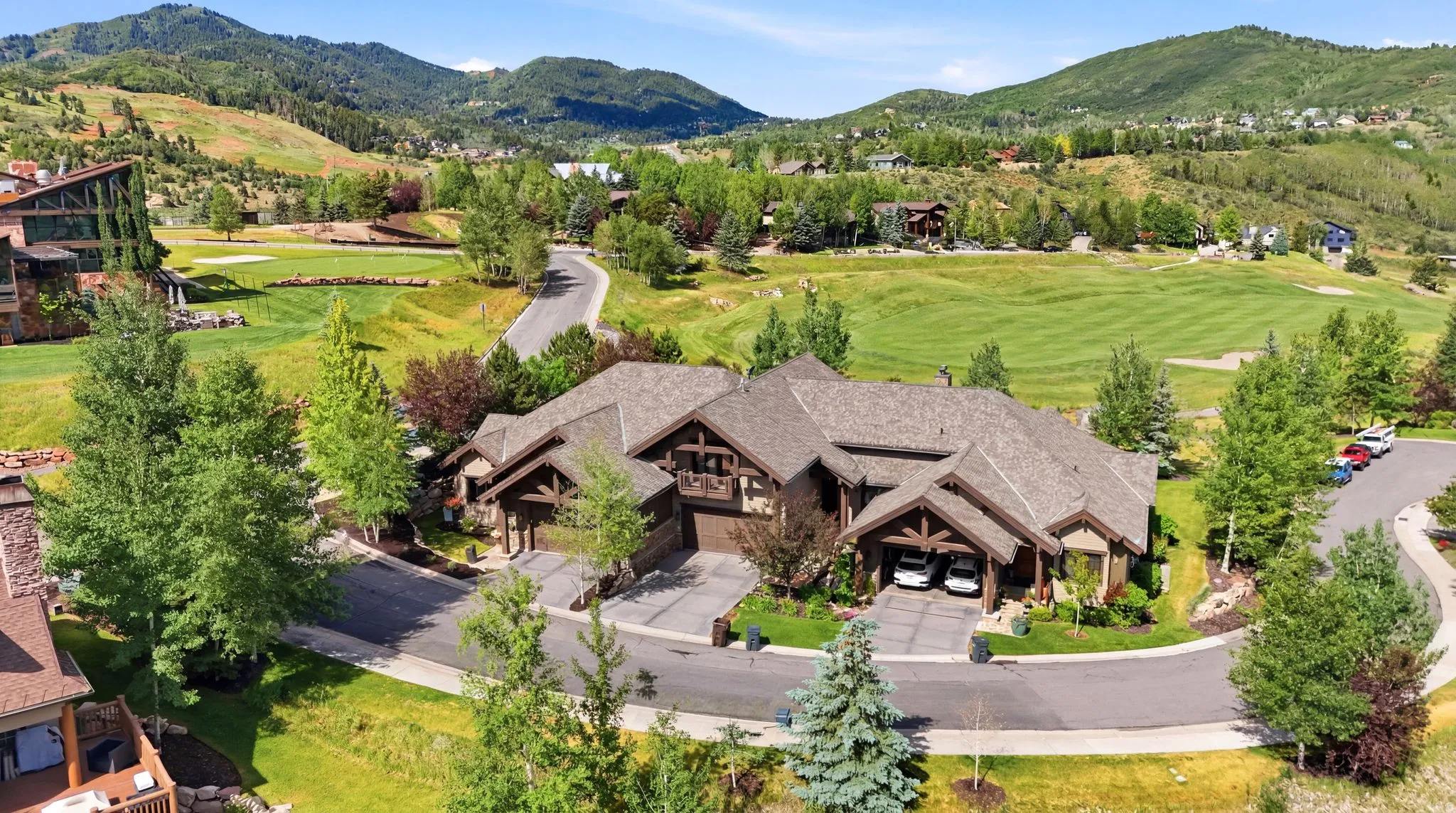 Expansive property featuring a multi-gabled roofline and a stone and wood exterior