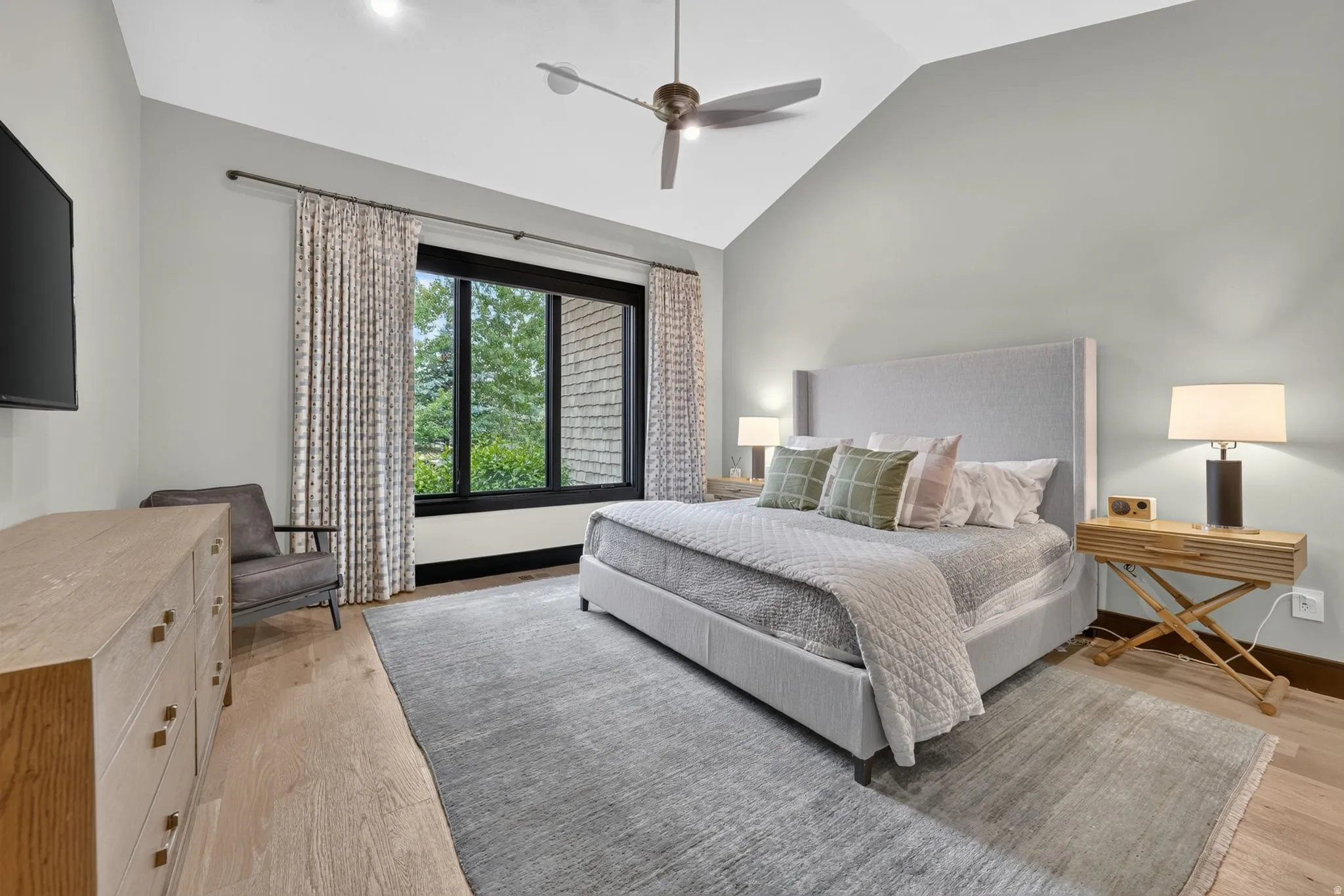 Light wood-finish flooring with a vaulted ceiling