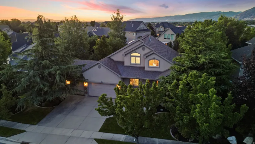 Single-family residence featuring a two-car garage and a paved driveway