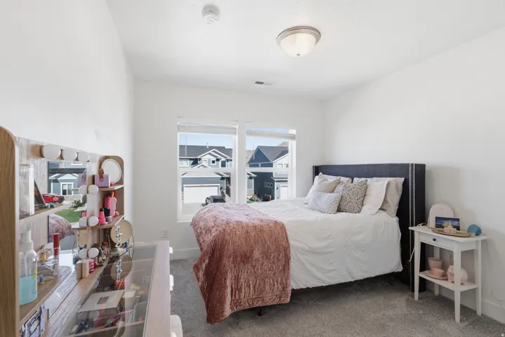 Light-filled room featuring a broad window, wall-to-wall carpeting, and a flush-mount ceiling light fixture