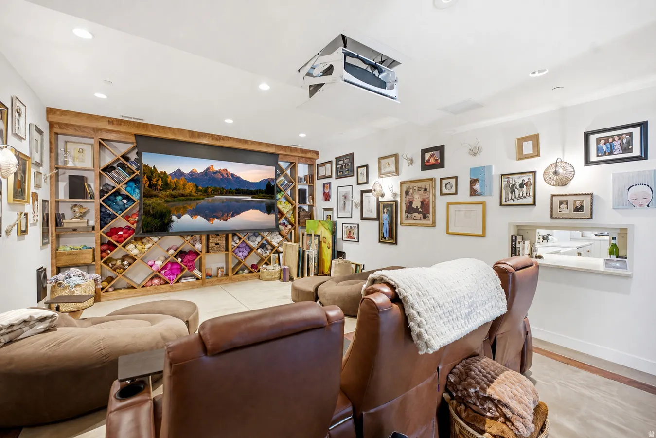 Dedicated media room featuring a large projection screen and ceiling-mounted projector