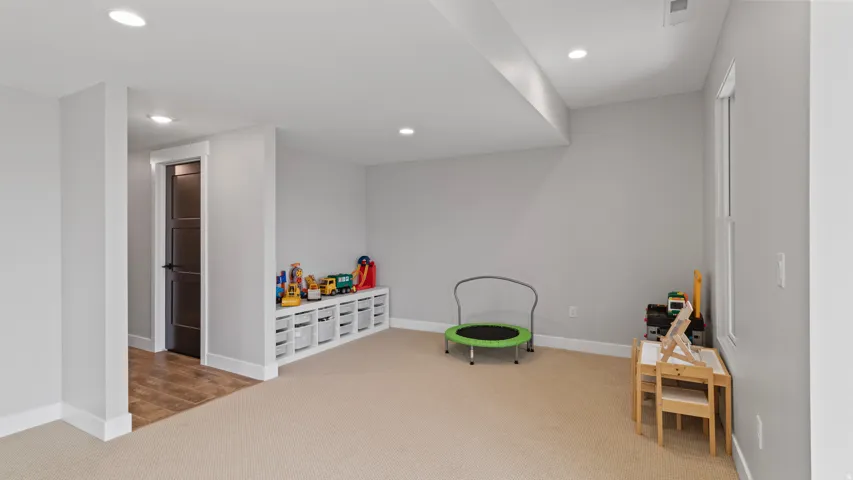 The large family/game room has two nooks that could be turned into a wet bar or even a second kitchen.  The nook with the toys backs to the furnace room and the one to the far left back up to one of the bathrooms.