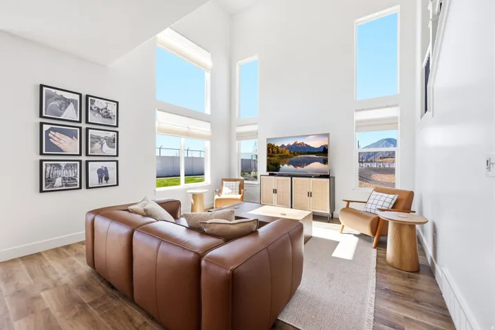 Living area featuring soaring ceilings and abundant natural light