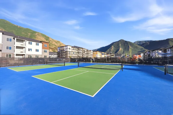 Multiple tennis courts with blue and green surfacing