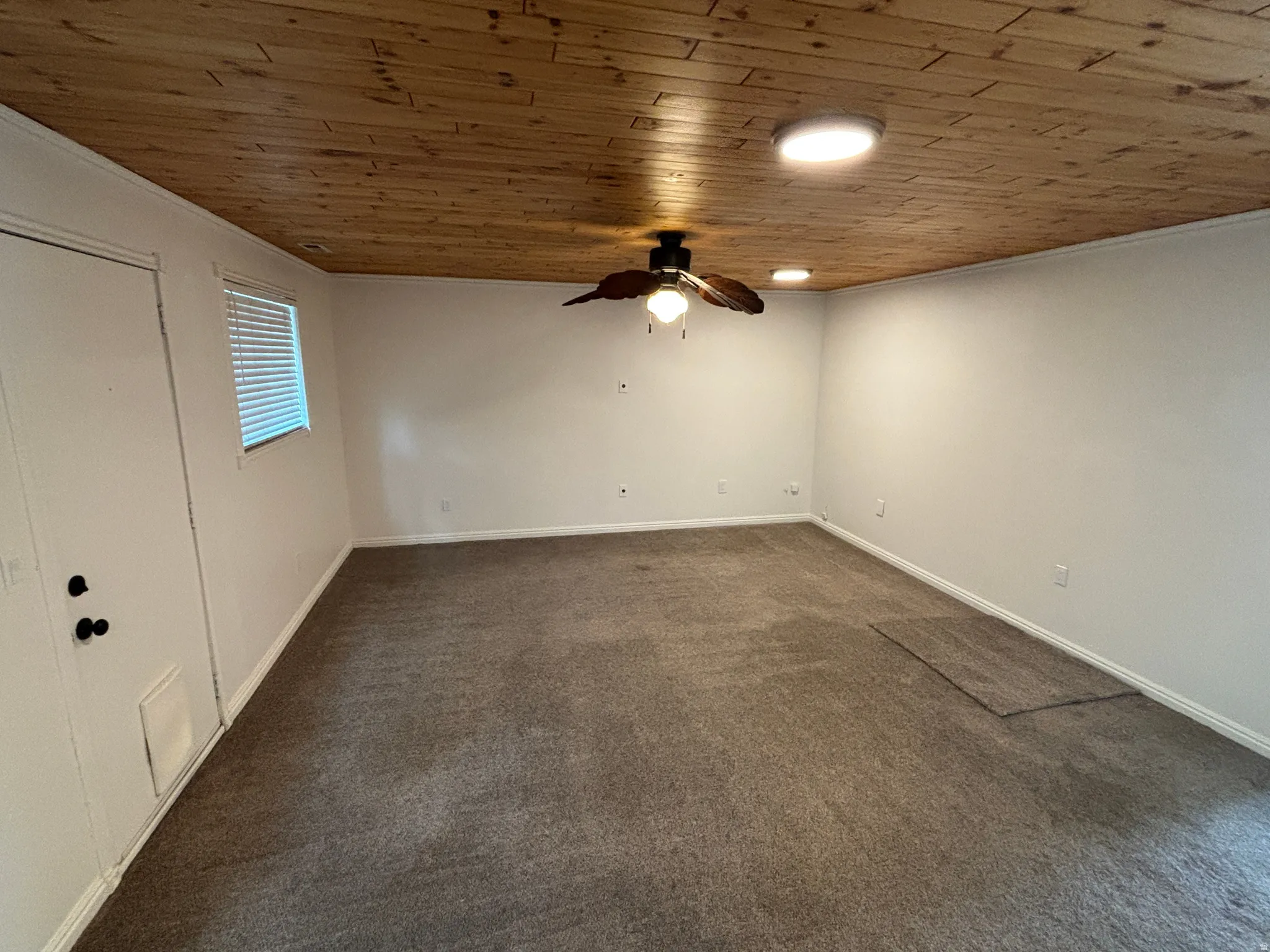Wood-paneled ceiling with recessed lighting and a ceiling fan
